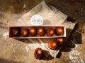 Six authentic French canelés with caramelized crust and vanilla rum custard heart, handmade in Venice Florida by French Atelier, French bakery.