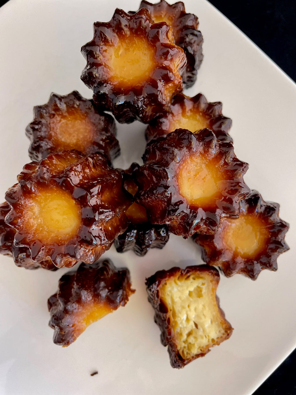 Authentic French canelés with caramelized crust and vanilla rum custard heart, handmade in Venice Florida by French Atelier, French bakery.