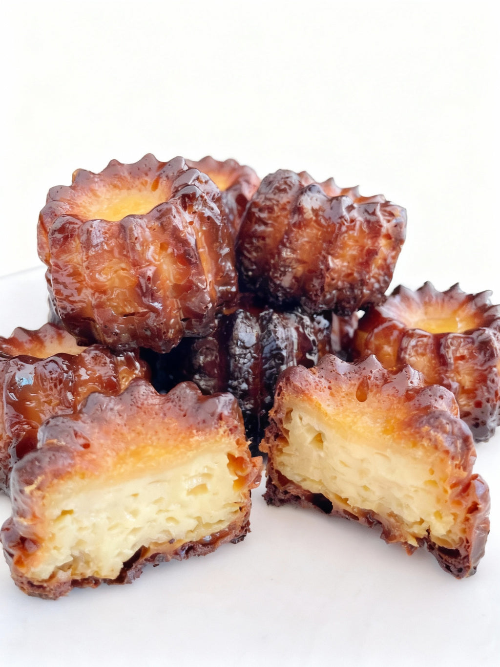 Authentic French canelés with caramelized crust and vanilla rum custard heart, handmade in Venice Florida by French Atelier, French bakery.
