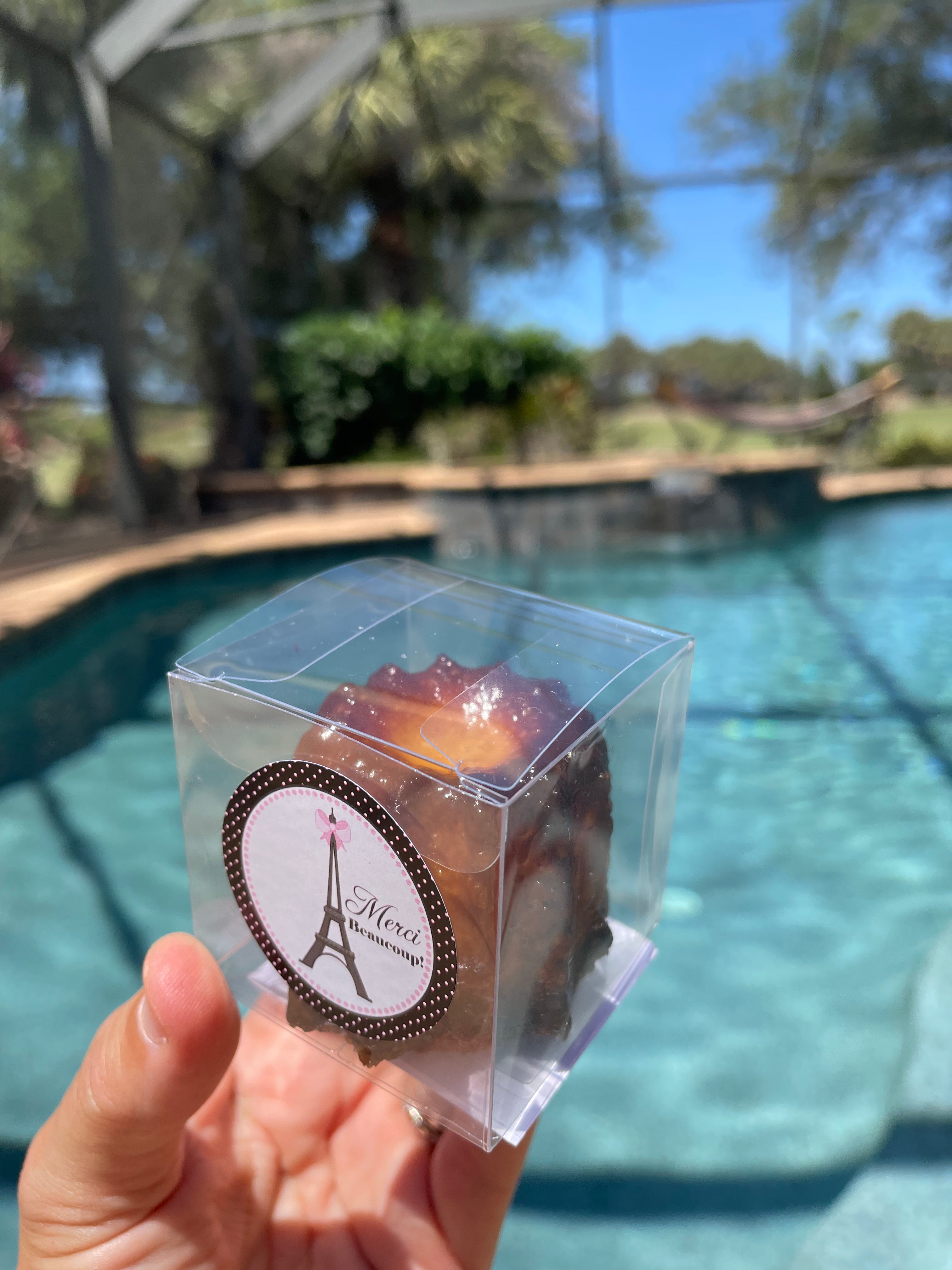 Individually wrapped French canelé favor with ribbon, perfect for all celebration: wedding, graduation, birthday or baby shower gifts in Sarasota and Venice. From French Atelier, a french bakery in Venice Florida.
