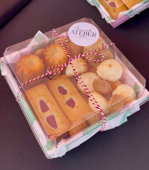 Box of assorted fresh french treats in pink  gift box, baked freshly by the French Atelier, a french bakery in Venice florida. Available online, at Siesta Key farmers market or in Venice Mercato, delivery on Sarasota area, Anna Maria, Casey Key, Lakewood ranch, Osprey, Port Charlotte, Punta Gorda, Englewood, Venice, Longboat Key, Bradenton and more.Perfect for your weeding, birthday party, corporate event and more. It's the perfect local edible treat!